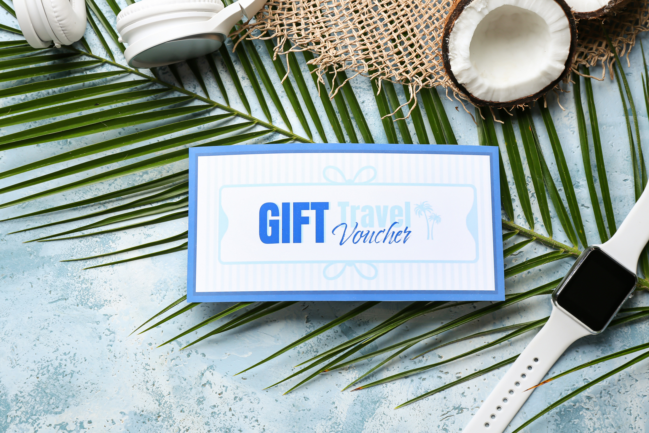 Travel Gift Voucher, Headphones and Smartwatch on Color Background